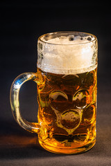Traditional Octoberfest Bavarian beer in a big one liter mug with wet walls, Germany
