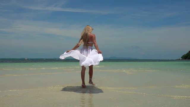 Young Caucasian Woman in White Skirt Walking on Tropical Sandy Beach