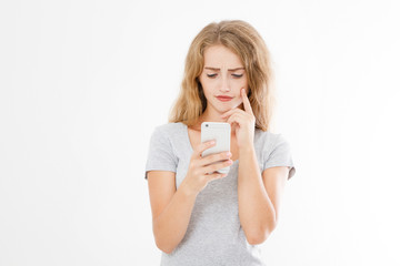 Young beautiful woman in t shirt using her smartphone isolated on white background. Sexy blond girl chating with friend or shopping online. Copy space