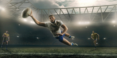 Dirty rugby player catch the ball in flight on professional rugby stadium - obrazy, fototapety, plakaty