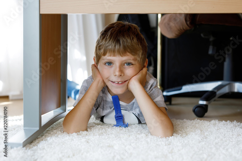 Beautiful Smiling Little Boy Portrait Under School Table Happy Kid Beautiful Smiling Little Boy Portrait Under School Table Happy Kid Looking At The