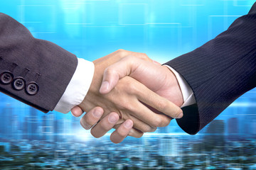 Business partnership successful and strategic plan concept , .Double exposure businessman handshake on modern city  building