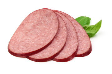 Salami smoked sausage slices with green basil leaves, isolated on white background