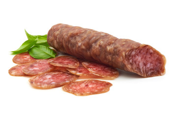 Smoked sausage with slices and green basil leaves, isolated on white background