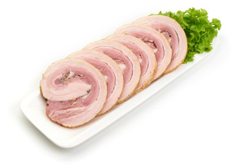 Twisted smoked pork meat slices with spices and herbs on the white plate, isolated on white background.