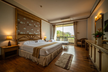 interia perspective of double hotel bedroom with one double bed and on extra bed for three persons at Samed Cabana Samed island Rayong district Thailand