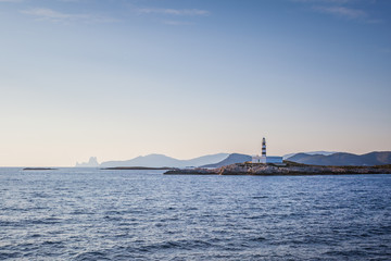 Beautiful view of the silhouette of Ibiza lighthouse taken from the sea