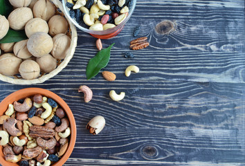 Different types of nuts and raisins on a wooden background nuts useful trace elements