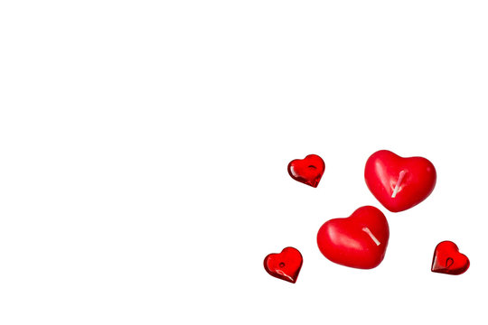    Valentine's Day. Small candles in the form of red hearts on a white background with copy space. 