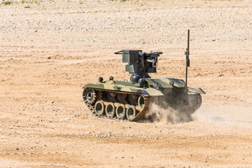 Maneuverable small armored personnel carrier with automatic weapons rides cross-country.