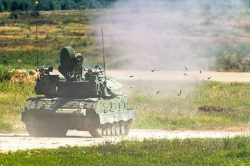 Shooting armored personnel carrier on the field during military operations. The falling lysis from...