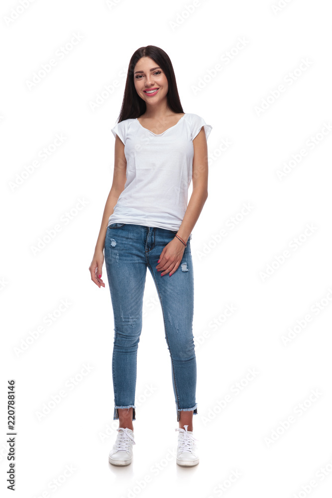 Wall mural sexy brunette casual girl wearing jeans and t-shirt standing