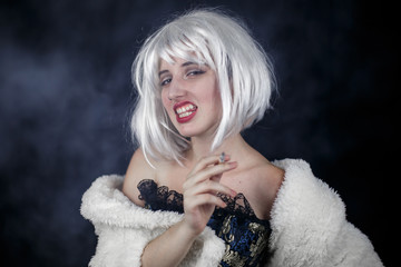 Attractive young woman in costume smoking cigar and looking at camera while standing on black...