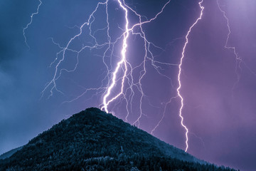 Lightning and hill. Storm in mountains