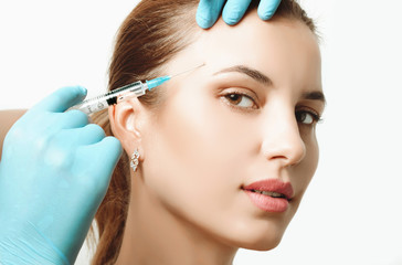 Woman getting cosmetic injection of botox in cheek, closeup