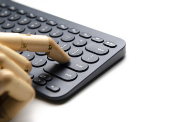 Wooden hand press enter button on black keyboard for technology concepthand