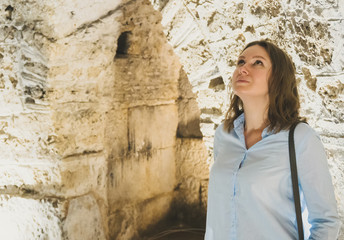 Female tourist in basement of Diocletian's Palace in Split, Croatia.