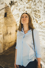 Female tourist in basement of Diocletian's Palace in Split, Croatia.