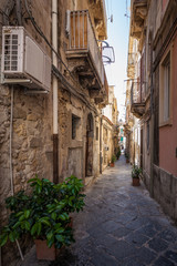 Fototapeta na wymiar View of narrow street in Syracuse, Italy, Sicily island