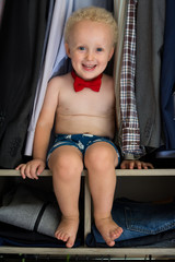 Little gentleman. Cute and handsome boy with curly blond hair wearing underpants and red bow tie,...
