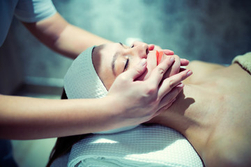Obraz na płótnie Canvas Facial massage treatment by professional at cosmetics saloon