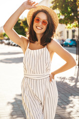 Portrait of beautiful cute blond teenager model in summer hipster clothes posing on the street background