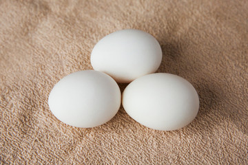 white chicken eggs on brown tablecloth