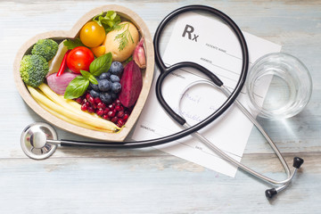 Healthy food in heart stethoscope and medical prescription diet and medicine concept
