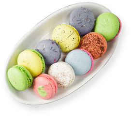 A plate of traditional french macaroons on a white background isolated top view