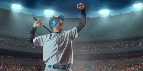 Baseball player happy emotionally rejoices in victory on professional baseball stadium