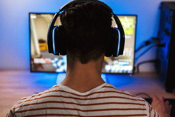 Back view of young gamer playing video games on computer © Drobot Dean
