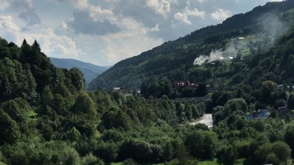 Mobile shaky footage of the railway in the Carpathians countryside at sunny day