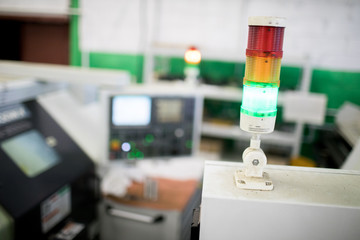 One of parts of industrial machine on its top among computers in workshop