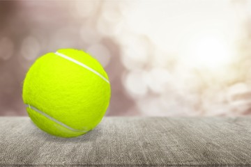 Bright yellow Tennis Ball isolated on white background. Closeup