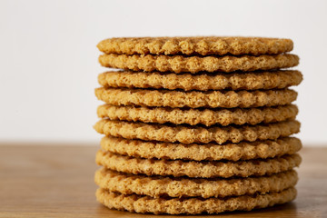 Wafers stacked in a pyramid on a wooden table. Copy space.