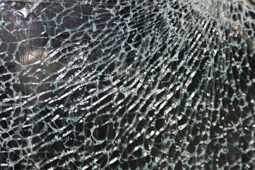 Texture of broken glass on dark background. Closeup