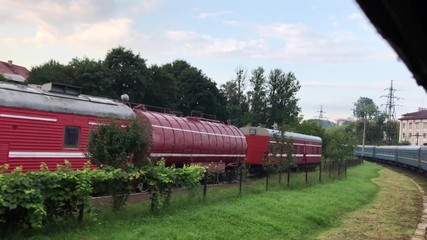 View from window of the passing train in the Carpathians countryside sunny day