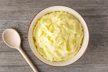 Puree from potatoes in a plate. Wooden background. Top Vieux. Macro.
