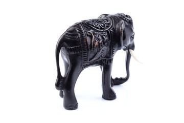 Black Engraved pattern gold elephant made of resin like wooden carving with white ivory. Stand on white background, Isolated, Art Model Thai Crafts, For decoration Like in the spa. 