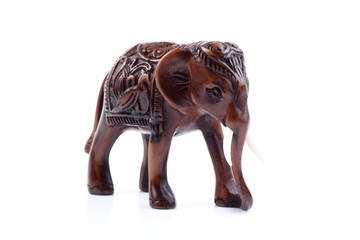 Brown Engraved pattern elephant like wooden carving with white ivory. Stand on white background, Isolated, Art Model Thai Crafts, For decoration Like in the spa.
