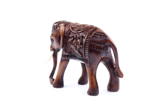 Brown Engraved pattern elephant like wooden carving with white ivory. Stand on white background, Isolated, Art Model Thai Crafts, For decoration Like in the spa.
