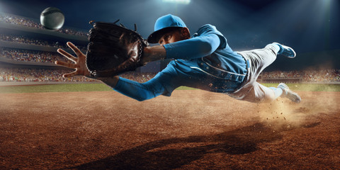 Fototapeta Baseball shortstop catches the ball on professional baseball stadium obraz