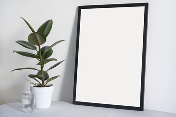 Poster in black frame in nordic stylish modern interior, ficus, living room. Empty space for design layout.