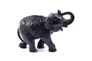 Fototapeta na wymiar Black Engraved pattern elephant made of resin like wooden carving with white ivory. Stand on white background, Isolated, Art Model Thai Crafts, For decoration Like in the spa.