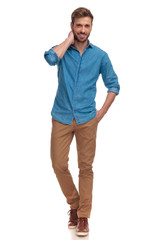 young casual man standing and posing on white background