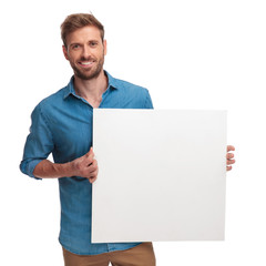 happy casual man holding a blank message