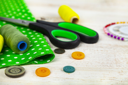 Sewing accessories and green fabric