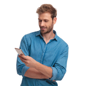 young happy casual man reads sms message on his  phone