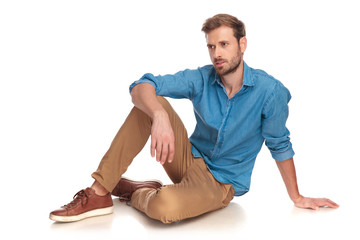 side view of a fashion man sitting down