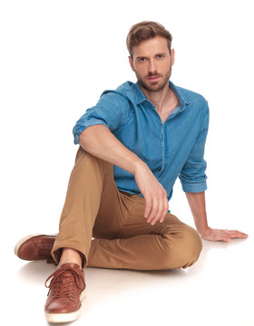 young fashion man posing while lying on the floor
